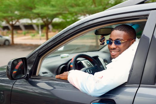 A Man in Sunglasses Driving a Car